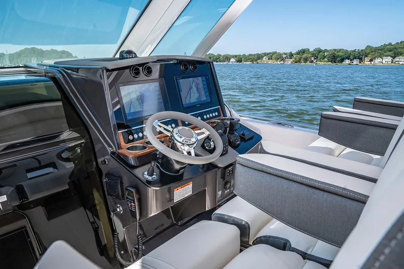 Slide: The Image of 2023 Tiara Yachts 34 LS boat docked, showcasing sleek design and spacious seating. - 6