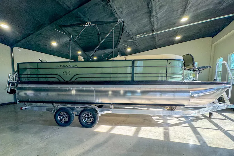 Slide: The Image of 2026 Veranda Vista 22F2/2/1 pontoon boat on trailer in showroom. - 3