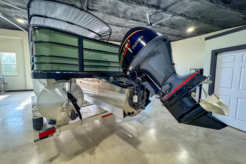 Slide: The Image of 2026 Veranda Vista 22F2/2/1 pontoon boat with powerful outboard motor in a garage setting. - 5