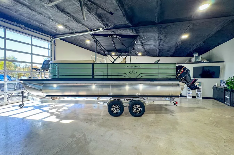 Slide: The Image of 2026 Veranda Vista 22F2/2/1 pontoon boat displayed indoors on a trailer. - 8