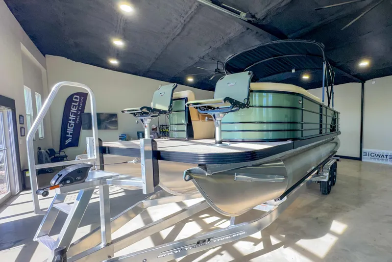 Slide: The Image of 2026 Veranda Vista 22F2/2/1 pontoon boat displayed indoors on a trailer. - 9