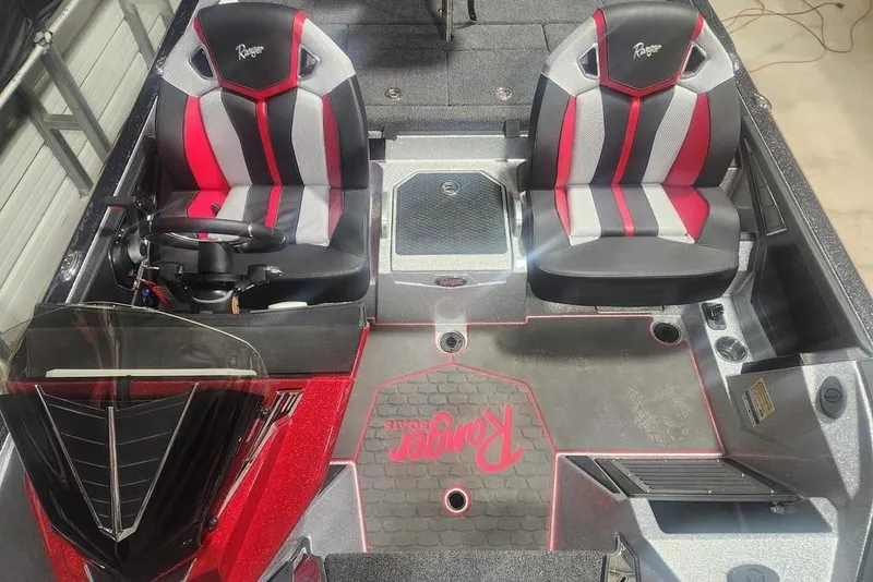 Slide: The Image of 2025 Ranger Z520R Cup-Equipped boat interior with red and black seats. - 10