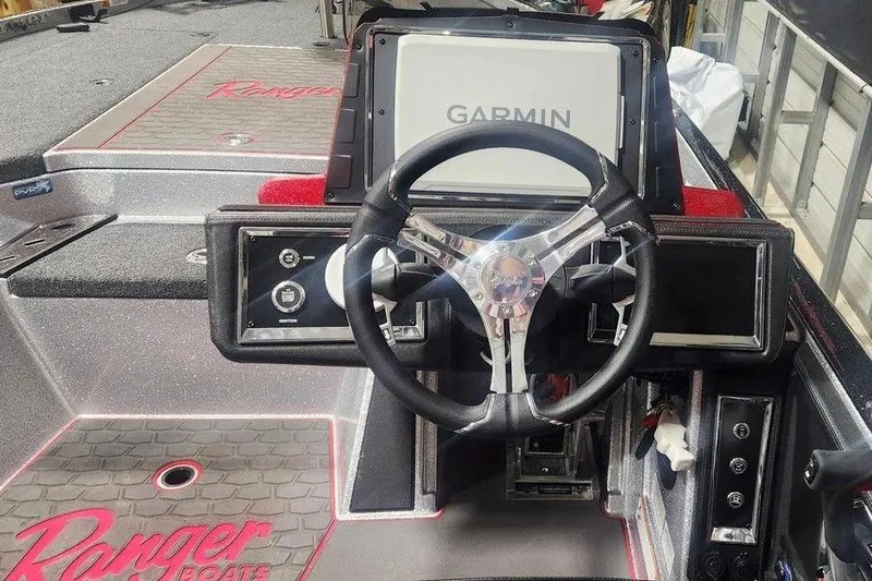 Slide: The Image of 2025 Ranger Z520R Cup-Equipped boat dashboard with Garmin display and steering wheel. - 4
