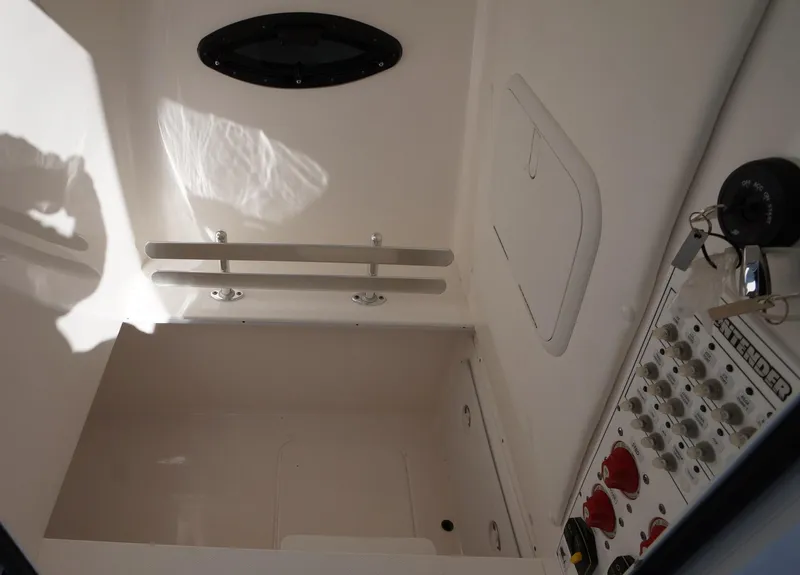 Slide: The Image of 2023 Contender 32 ST boat interior with control panel and storage compartment. - 21