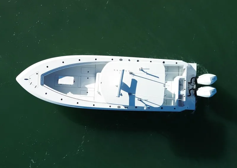Slide: The Image of 2023 Contender 32 ST boat, aerial view, cruising on green water. - 6