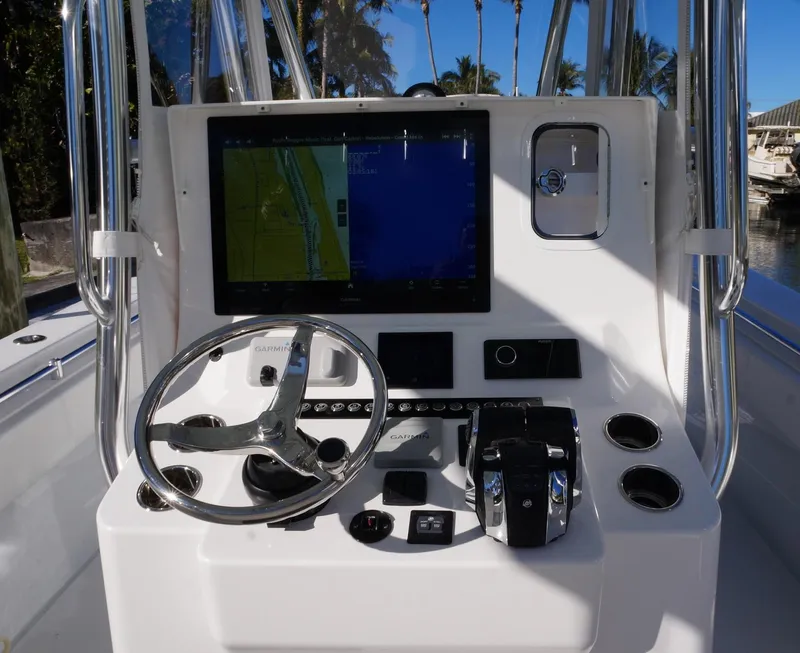 Slide: The Image of 2023 Contender 32 ST boat dashboard with steering wheel and navigation display. - 8