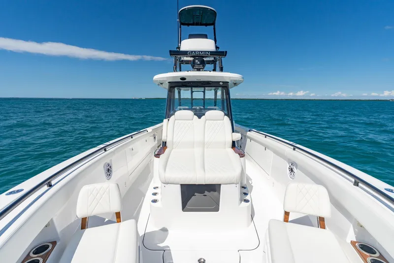 Slide: The Image of 2025 Everglades 375 Center Console boat on open sea, clear sky, luxurious seating. - 10