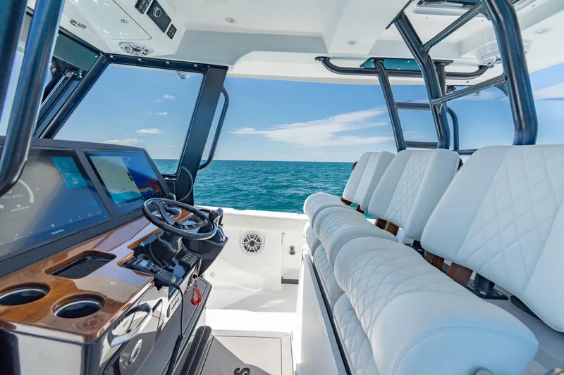 Slide: The Image of 2025 Everglades 375 Center Console interior with ocean view, featuring modern helm and seating. - 13