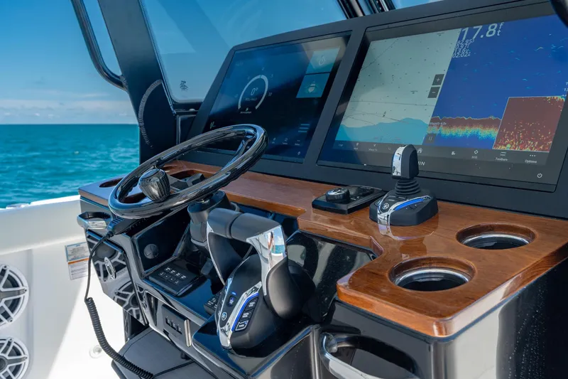 Slide: The Image of 2025 Everglades 375 Center Console dashboard with advanced navigation screens and controls. - 14