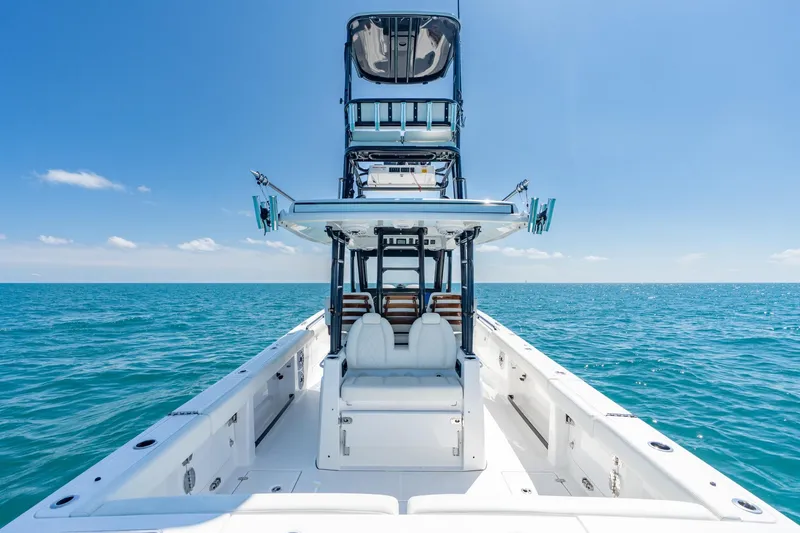 Slide: The Image of 2025 Everglades 375 Center Console boat on open sea under clear blue sky. - 17