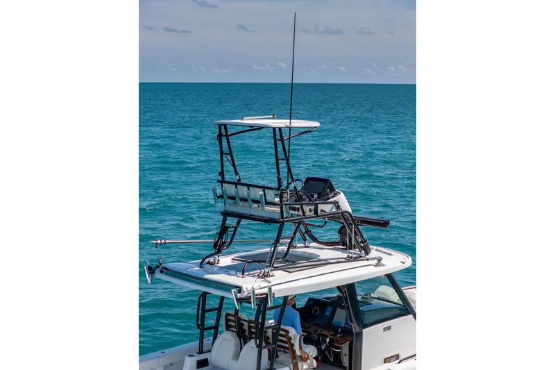 Slide: The Image of 2025 Everglades 375 Center Console boat on open sea, featuring elevated helm station. - 22