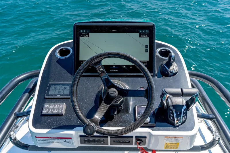 Slide: The Image of 2025 Everglades 375 Center Console helm with Garmin display on open water. - 24