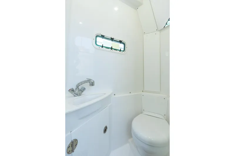 Slide: The Image of 2025 Everglades 375 Center Console boat interior bathroom with sink and toilet. - 28