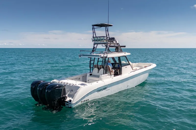 Slide: The Image of 2025 Everglades 375 Center Console boat on open ocean, featuring triple outboard engines. - 29