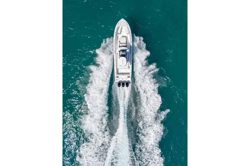 Slide: The Image of Aerial view of 2025 Everglades 375 Center Console boat cruising on turquoise water. - 3
