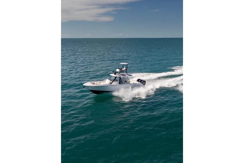 Slide: The Image of 2025 Everglades 375 Center Console boat cruising on open ocean waters. - 4