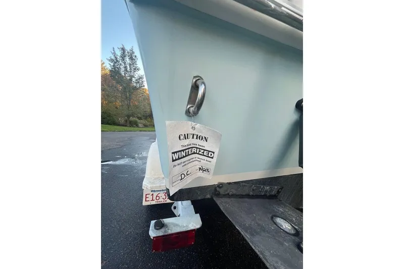 Slide: The Image of 2005 Sailfish 218 WAC boat with winterization caution tag on trailer. - 12