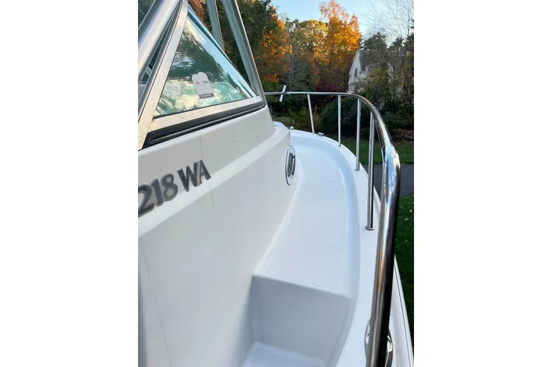 Slide: The Image of 2005 Sailfish 218 WAC boat deck with railing, surrounded by autumn foliage. - 15