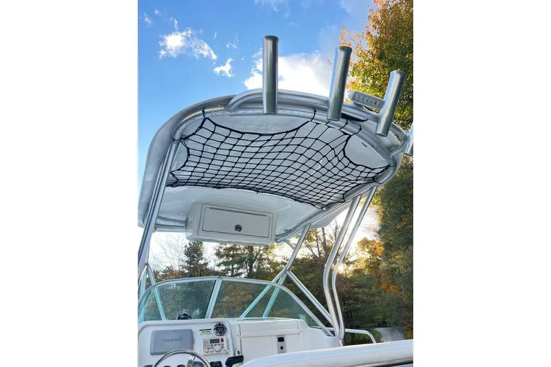 Slide: The Image of 2005 Sailfish 218 WAC boat with T-top and rod holders against blue sky. - 21