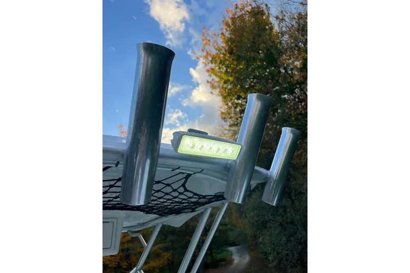 Slide: The Image of Stainless steel rod holders on 2005 Sailfish 218 WAC boat under a blue sky. - 27