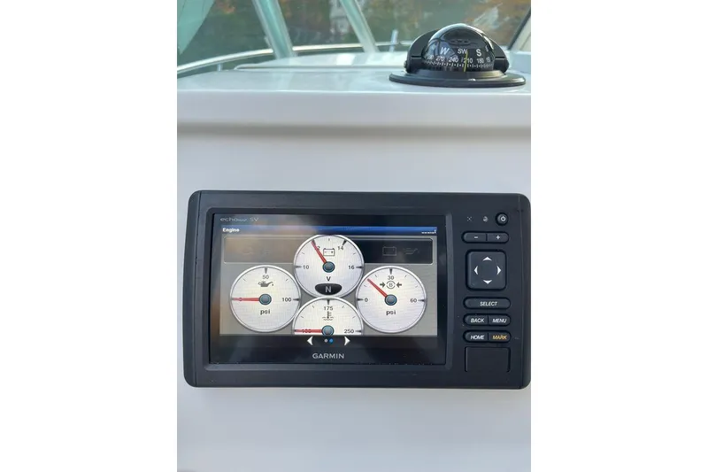 Slide: The Image of Garmin marine display on 2005 Sailfish 218 WAC boat dashboard with compass. - 28