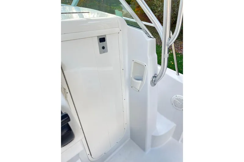 Slide: The Image of 2005 Sailfish 218 WAC boat interior with white console and stainless steel railings. - 32