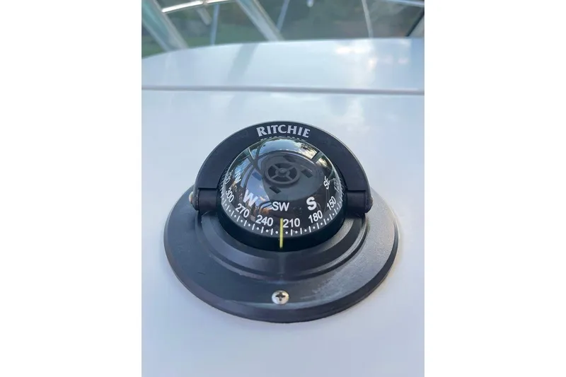 Slide: The Image of Ritchie compass on 2005 Sailfish 218 WAC boat dashboard, showing directional bearings. - 36