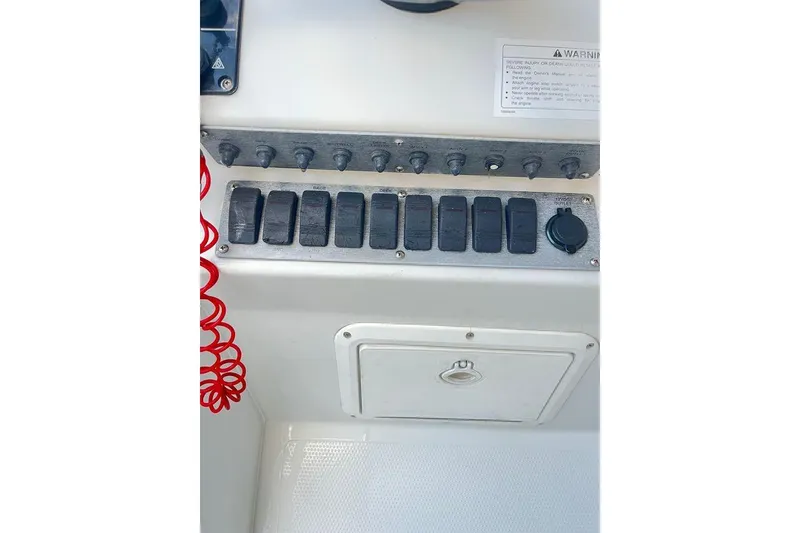Slide: The Image of Control panel of a 2005 Sailfish 218 WAC boat with switches and warning label. - 40