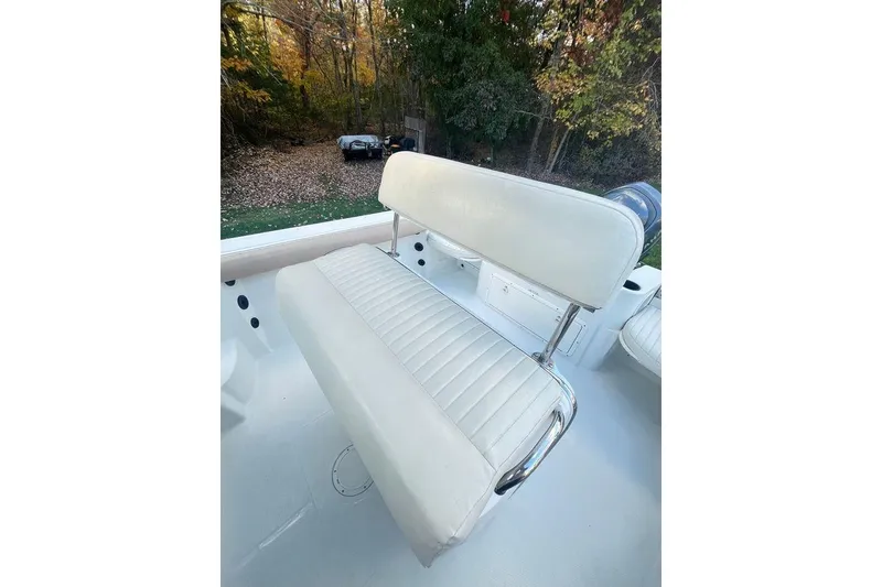 Slide: The Image of 2005 Sailfish 218 WAC boat interior with white cushioned seating and wooded background. - 43