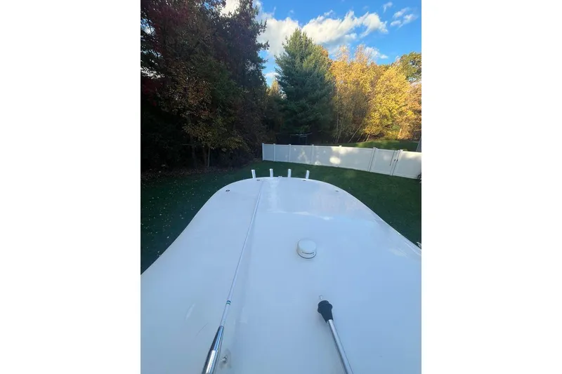 Slide: The Image of 2005 Sailfish 218 WAC boat deck, surrounded by trees and a white fence. - 44