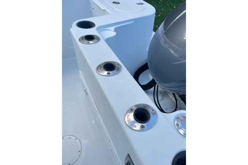 Slide: The Image of 2005 Sailfish 218 WAC boat with rod holders and engine detail. - 51