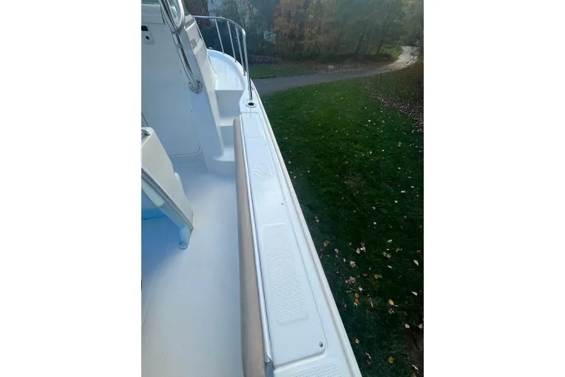 Slide: The Image of 2005 Sailfish 218 WAC boat deck, white interior, outdoor setting. - 52