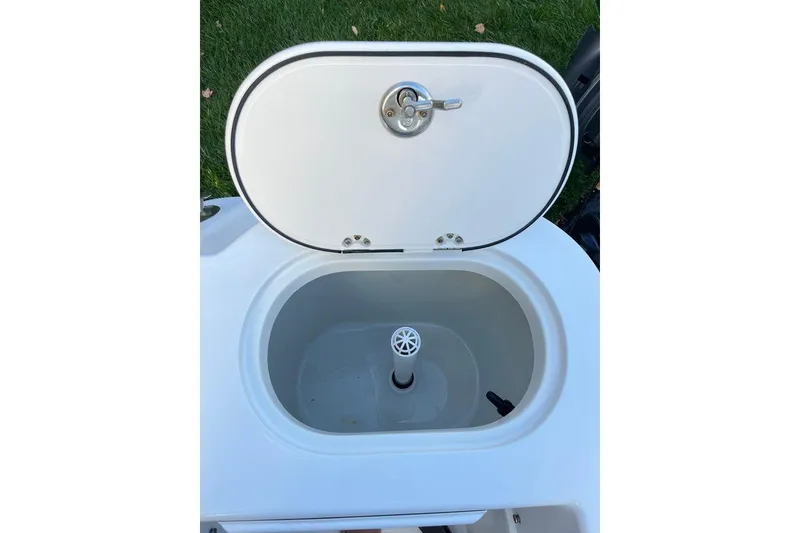 Slide: The Image of Open hatch on 2005 Sailfish 218 WAC boat, revealing storage compartment. - 53