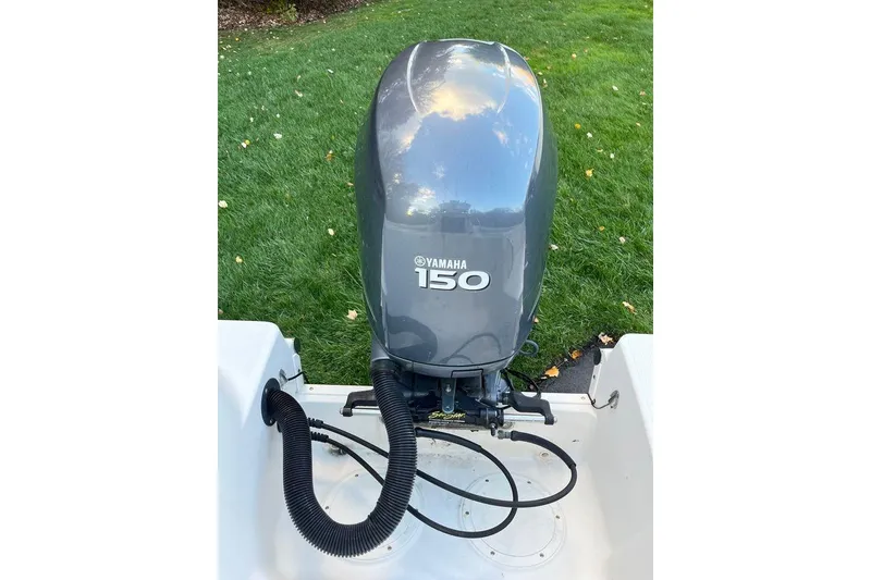 Slide: The Image of Yamaha 150 outboard motor on 2005 Sailfish 218 WAC boat, grassy background. - 54