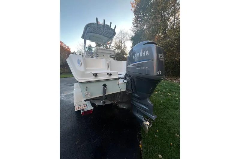 Slide: The Image of 2005 Sailfish 218 WAC boat with Yamaha 150 outboard motor, parked outdoors. - 6