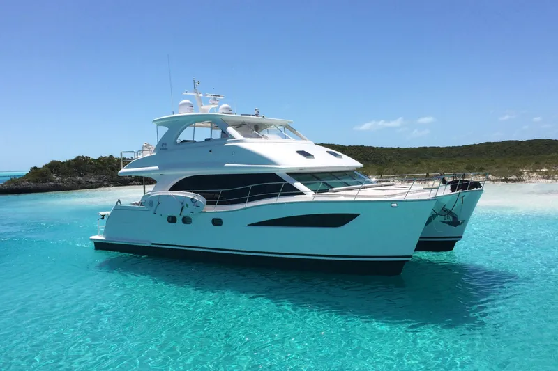The Image of Luxurious 2016 Horizon PC52 yacht in clear turquoise waters, near a lush island. - 0