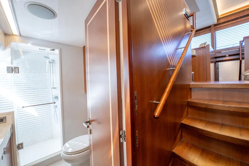 Slide: The Image of Luxurious 2016 Horizon PC52 yacht interior with wooden stairs and modern bathroom. - 10