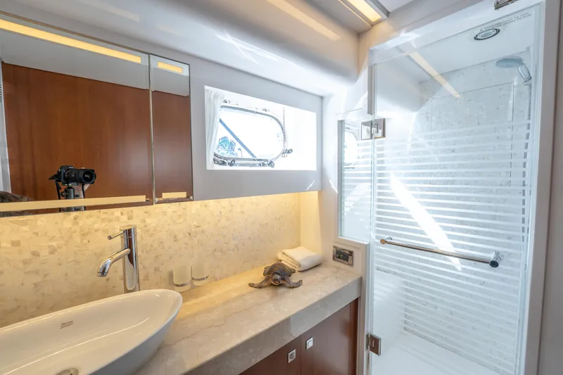 Slide: The Image of Luxurious bathroom in 2016 Horizon PC52 yacht with modern fixtures and elegant design. - 12