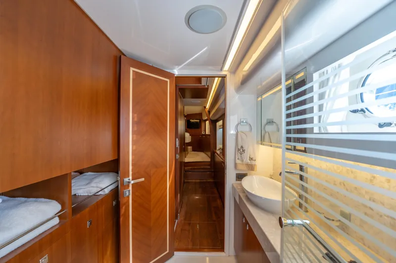Slide: The Image of Luxurious bathroom interior on 2016 Horizon PC52 yacht with modern fixtures and wood accents. - 13