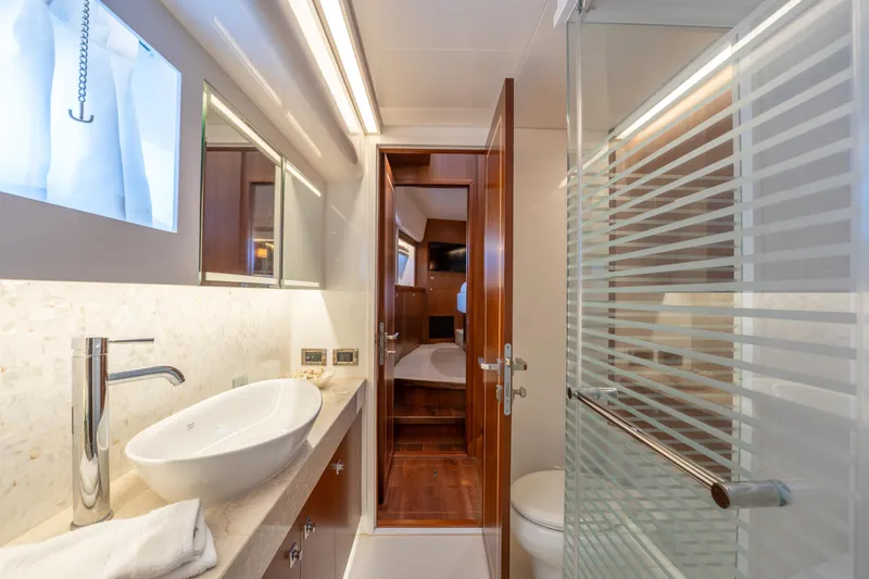 Slide: The Image of Luxurious bathroom interior on 2016 Horizon PC52 yacht, featuring modern fixtures and elegant design. - 25
