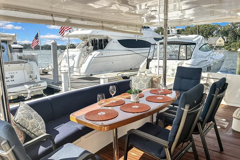 Slide: The Image of Luxurious Horizon PC52 yacht deck with elegant dining setup, docked at marina, 2016 model. - 30