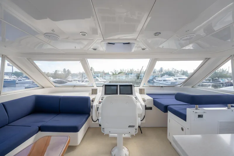 Slide: The Image of Luxurious 2016 Horizon PC52 yacht interior with blue seating and panoramic windows. - 32
