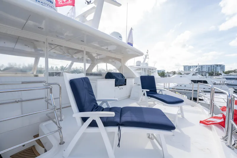 Slide: The Image of Luxury Horizon PC52 yacht deck with blue cushioned chairs, 2016 model, docked at marina. - 38