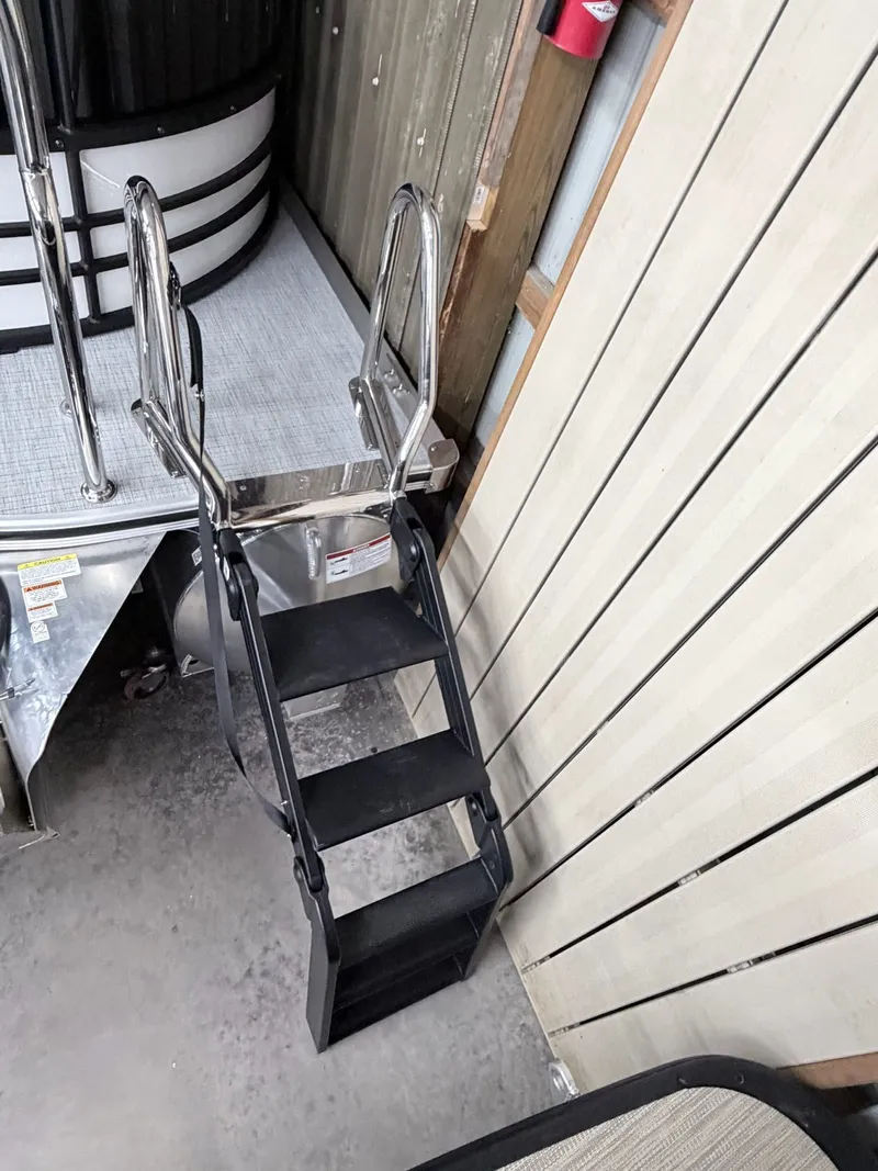 Slide: The Image of Berkshire CTS Series 22RFX CTS 2026 boat ladder in storage area. - 24