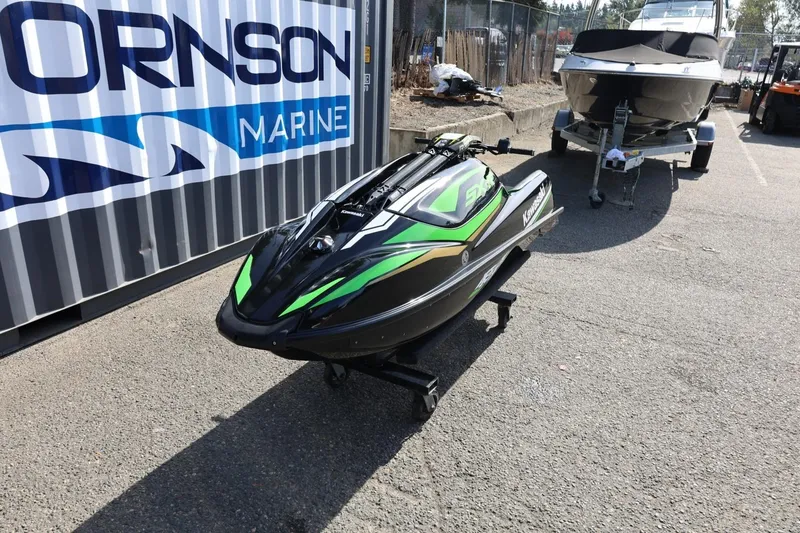 Slide: The Image of 2022 Kawasaki Jetski SX-R in a marina setting, black and green design. - 10