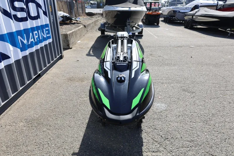 Slide: The Image of 2022 Kawasaki Jetski SX-R in a marina parking lot, front view. - 11