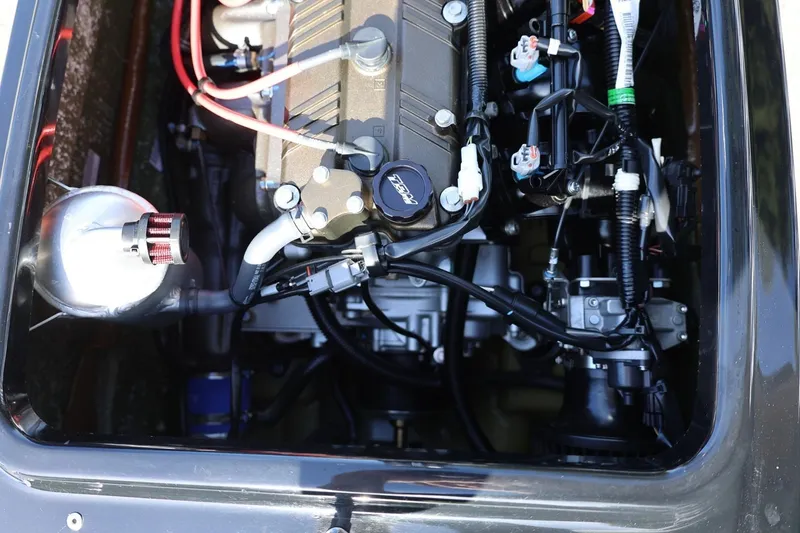 Slide: The Image of Engine compartment of a 2022 Kawasaki Jetski SX-R, showcasing intricate mechanical components. - 14