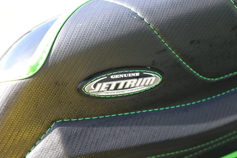 Slide: The Image of Close-up of 2022 Kawasaki Jetski SX-R seat with Jettrim logo and green stitching. - 16