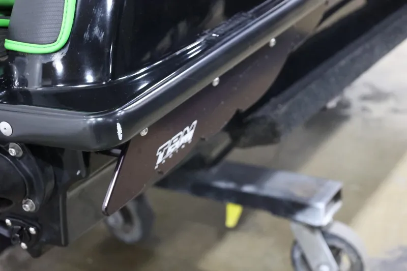 Slide: The Image of 2022 Kawasaki Jetski SX-R rear detail with green accents on a stand. - 22