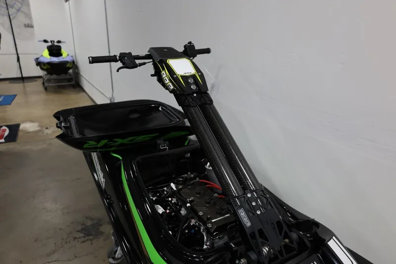 Slide: The Image of 2022 Kawasaki Jetski SX-R in a garage, showcasing handlebars and engine components. - 25